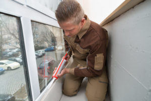 Man Sealing Windows